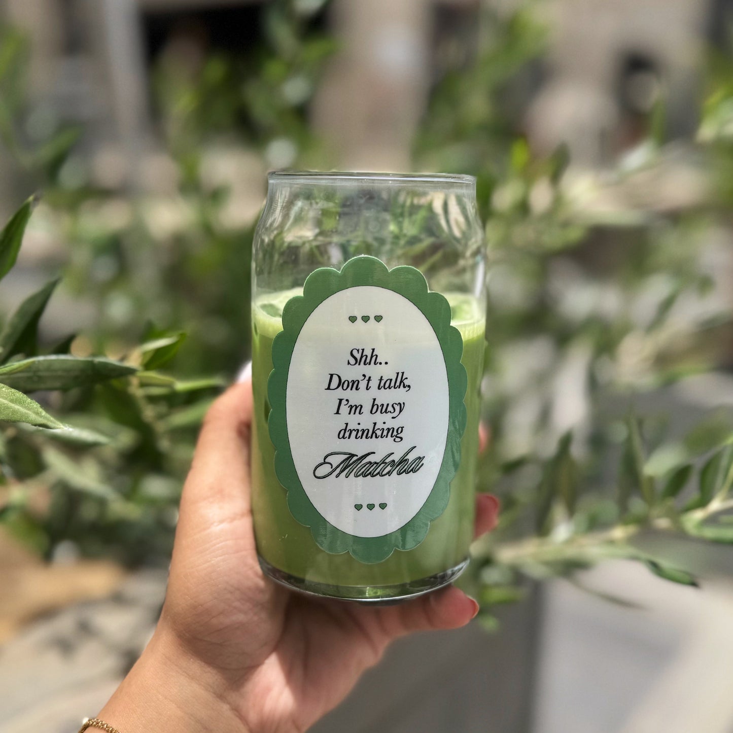 “Busy drinking matcha.” Glass cup